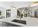 Kitchen island with sink, modern faucet, and white quartz countertops at 8917 Grand Highland Way, Wake Forest, NC 27587