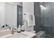 Modern bathroom with gray tile, glass shower, and updated vanity at 8917 Grand Highland Way, Wake Forest, NC 27587