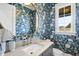 Stylish powder room with blue floral wallpaper and modern vanity at 8917 Grand Highland Way, Wake Forest, NC 27587