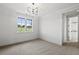 Bright bedroom with a large window, neutral walls, and carpeted floor at 8917 Grand Highland Way, Wake Forest, NC 27587