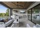 Covered outdoor kitchen and patio with built in grill, TV and comfortable seating at 8917 Grand Highland Way, Wake Forest, NC 27587