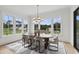 Bright dining room with large windows and wood table at 8917 Grand Highland Way, Wake Forest, NC 27587