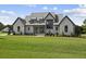Modern farmhouse exterior with metal roof at 8917 Grand Highland Way, Wake Forest, NC 27587