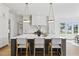 Modern kitchen with large island, white cabinets, and stainless steel appliances at 8917 Grand Highland Way, Wake Forest, NC 27587