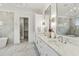 Elegant bathroom with double vanity, marble counters, and a soaking tub at 8917 Grand Highland Way, Wake Forest, NC 27587