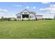 Modern farmhouse with lush green lawn at 8917 Grand Highland Way, Wake Forest, NC 27587