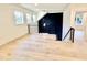 Open loft area with hardwood floors, modern railing, and dark accent wall at 113 Boyd St, Cary, NC 27513