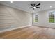 Spacious bedroom with hardwood floors and geometric accent wall at 20 Carnation Rd, Youngsville, NC 27596