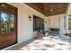 Charming front porch features a wooden swing and rocking chairs at 34 Chestnut Creek Way, Chapel Hill, NC 27516