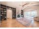 Bright living room with a fireplace, built-in shelves, and hardwood floors at 34 Chestnut Creek Way, Chapel Hill, NC 27516