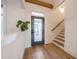 Bright entryway with hardwood floors, modern door, and staircase at 34 Chestnut Creek Way, Chapel Hill, NC 27516
