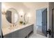 Bathroom with double vanity, round mirrors, and hexagon tile floor at 34 Chestnut Creek Way, Chapel Hill, NC 27516
