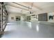 Spacious garage with epoxy flooring, overhead storage, and glass garage doors at 34 Chestnut Creek Way, Chapel Hill, NC 27516