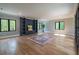 Large bonus room with hardwood floors, built-in shelving, and abundant natural light at 34 Chestnut Creek Way, Chapel Hill, NC 27516