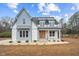 Modern farmhouse exterior with light blue siding and metal roof at 10 Carnation Rd, Youngsville, NC 27596