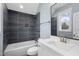 Modern bathroom with dark tile shower and white vanity at 10 Carnation Rd, Youngsville, NC 27596