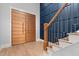 Bright entryway with double wood doors and modern staircase at 10 Carnation Rd, Youngsville, NC 27596