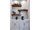 Bright pantry with white cabinets, wood shelves, and marble backsplash at 4217 Burlington Mills Rd, Wake Forest, NC 27587