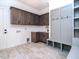 Laundry room with wooden cabinets and built-in bench at 160 Pondhurst Ln, Fuquay Varina, NC 27526