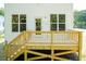 Elevated wooden deck with railing and stairs at 804 N Magnolia Ave, Dunn, NC 28334