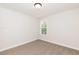 Well-lit bedroom with neutral decor and carpeted floor at 804 N Magnolia Ave, Dunn, NC 28334