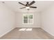 Bright bedroom with neutral walls, carpet, and a ceiling fan at 804 N Magnolia Ave, Dunn, NC 28334