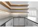 Modern wet bar with gray countertop and wooden floating shelves at 8417 Portmarnock Ct, Wake Forest, NC 27587