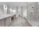 Spa-like bathroom with double vanity, marble shower, and hexagon tile floors at 8417 Portmarnock Ct, Wake Forest, NC 27587
