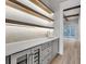 Butlers pantry with gray cabinets, quartz countertop, and wine fridge at 8417 Portmarnock Ct, Wake Forest, NC 27587