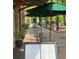 Outdoor cafe patio with green umbrellas and menu board at 714 Chatham View Rd # 17, Cary, NC 27511