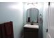 Small bathroom with pedestal sink and decorative mirror at 617 Casey Ln, Mebane, NC 27302