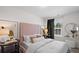 Bright bedroom with a pink upholstered headboard, plush bedding, and a window with green curtains at Tbd Channel Drop Dr # 123, Clayton, NC 27520