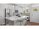 Modern kitchen with white cabinets, stainless steel appliances, and a large quartz island at Tbd Channel Drop Dr # 94, Clayton, NC 27520