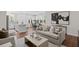 Open living room and kitchen with hardwood floors, neutral color palette and large windows at Tbd Channel Drop Dr # 94, Clayton, NC 27520