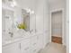 Double vanity bathroom with white cabinets and walk-in closet at 2009 Abbeyhill Dr, Raleigh, NC 27610