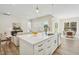 Open concept kitchen with white cabinets and large island at 2009 Abbeyhill Dr, Raleigh, NC 27610