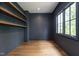 Spacious home office with dark-painted walls, hardwood floors, and built-in shelves at 904 Havens Edge Ct, Apex, NC 27523