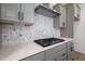 Gas cooktop with stainless steel range hood and hexagon backsplash at 108 Swain St, Clayton, NC 27527