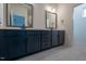Bathroom with double vanity and dark blue cabinets at 108 Swain St, Clayton, NC 27527