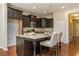 Modern kitchen with dark cabinets, granite countertops, and stainless steel appliances at 364 Dasu Dr, Clayton, NC 27520