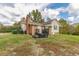Brick and siding house exterior with deck and landscaping at 1054 George Bason Rd, Graham, NC 27253