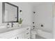 Clean bathroom with white subway tile, bathtub, and modern vanity at 6413 Tanner Oak Ln, Raleigh, NC 27613