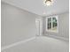 Bright bedroom with large window and neutral wall colors at 2651 Marchmont St, Raleigh, NC 27608