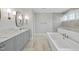 Luxurious bathroom with soaking tub, walk-in shower, and marble vanity at 2651 Marchmont St, Raleigh, NC 27608