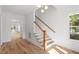Bright entryway with hardwood floors and staircase leading upstairs at 2408 Everett Ave, Raleigh, NC 27607