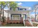 Craftsman style home with brick facade, front porch, and a landscaped lawn at 2408 Everett Ave, Raleigh, NC 27607