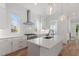 Modern kitchen featuring white cabinets, stainless steel appliances, and marble countertops at 2408 Everett Ave, Raleigh, NC 27607