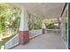 Spacious covered porch with brick columns and white railings at 2408 Everett Ave, Raleigh, NC 27607