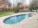 Inviting kidney-shaped pool with a spa and a spacious patio at 7621 Wingfoot Dr, Raleigh, NC 27615