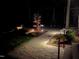 Landscaped backyard patio at night at 213 Westhampton Dr, Pittsboro, NC 27312